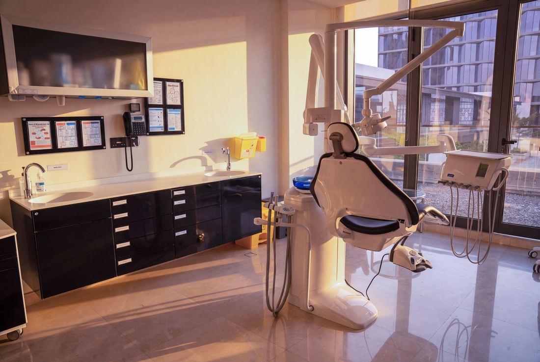 A Tam Dental treatment room in Jeddah with a dental chair beside a floor-to-ceiling window.